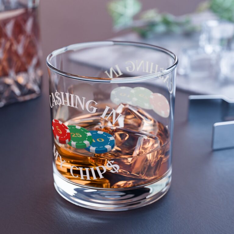 Ca$hing In My Chip$ 10oz rocks glass filled with whiskey and ice, featuring the signature poker chip logo design on a premium clear glass.